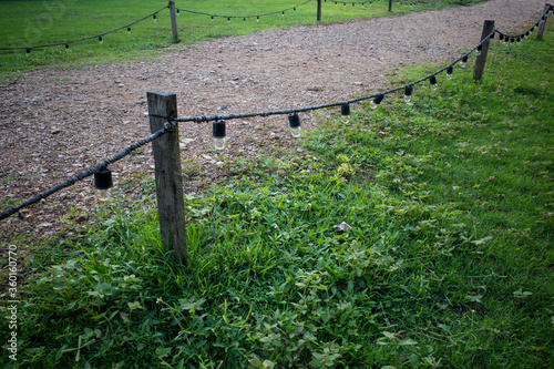 Wallpaper Mural Gravel walking path in a grass field/lawn with light bulb fence Torontodigital.ca