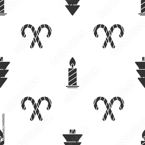 Set Christmas tree, Burning candle in candlestick and Christmas candy cane with stripes on seamless pattern. Vector.