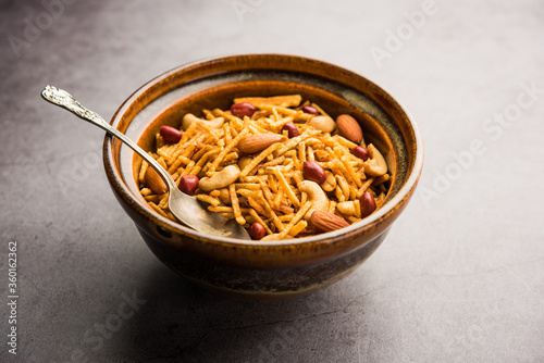 Aloo Chivda or Potato Chiwda also known as Falahari Namkeen for Vrat.  Traditional Fasting snack recipe from India, garnished with Cashew Nuts and Almonds photo