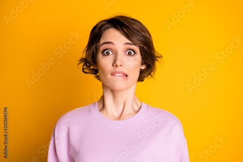 Close-up portrait of her she nice attractive lovely cute worried scared depressed girl biting lip waiting bad news isolated on bright vivid shine vibrant yellow color background