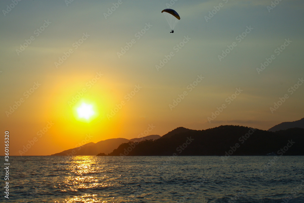 Small waves on the south coast of Turkey, a storm in the Mediterranean Sea, Oludeniz, Mugla, Fethiye. Rocky mountains that go to sea. National park, a popular tourist destination, sunset at sea