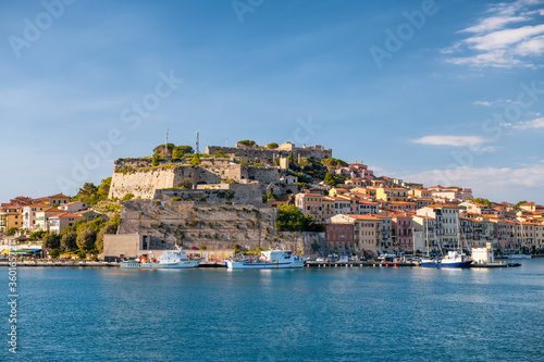 Fototapeta Naklejka Na Ścianę i Meble -  PORTOFERRAIO, ITALY - JUNE 22, 2020: City buildings of Elba Island on a sunny day