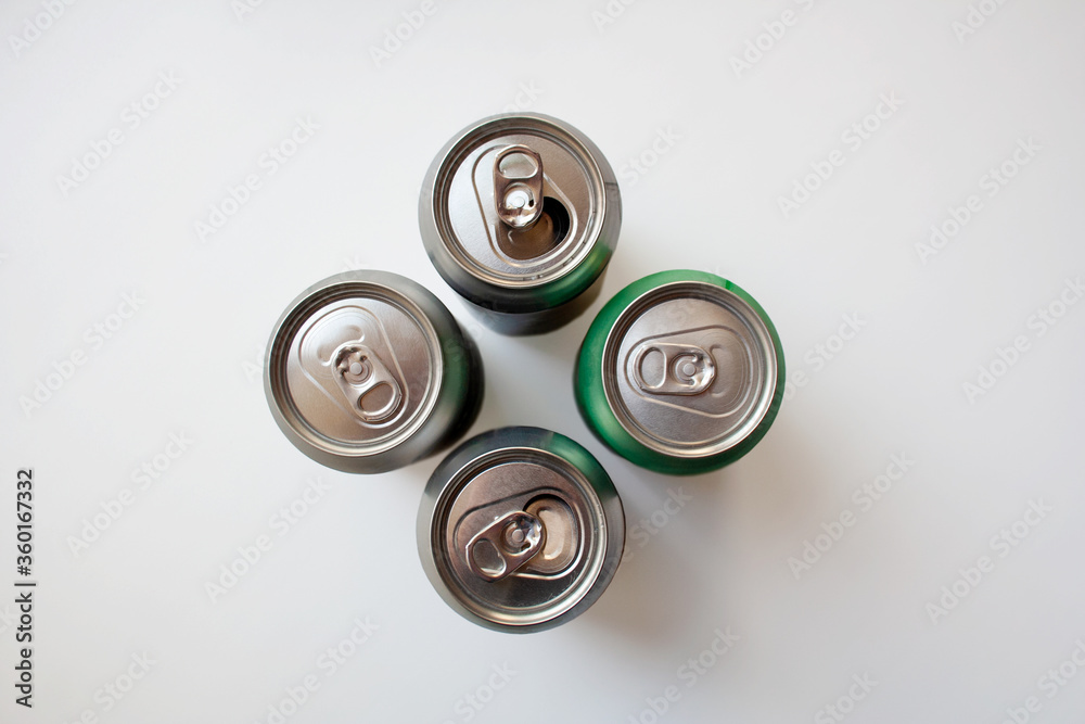 Four metal drink cans isolated on white background from a high angle view Four metal drink cans isolated on white background from a high angle view
