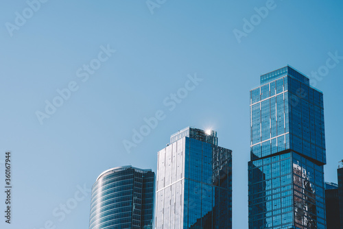 View of modern tall skyscrapers in business center of Moscow city against blue sky background, contemporary office buildings in rich district, high-rise new towers in metropolis