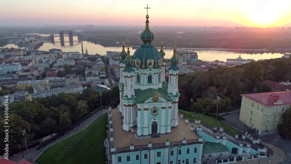 Kyiv, Ukraine. Flying around St. Andrew's Church of Ecumenical Patriarchate, Orthodox Church during sunrise. View of Podil and Dnieper River. Aerial shot, 4K Kyiv, Ukraine. Flying around St. Andrew's Church of Ecumenical Patriarchate, Orthodox Church during sunrise. View of Podil and Dnieper River. Aerial shot, 4K