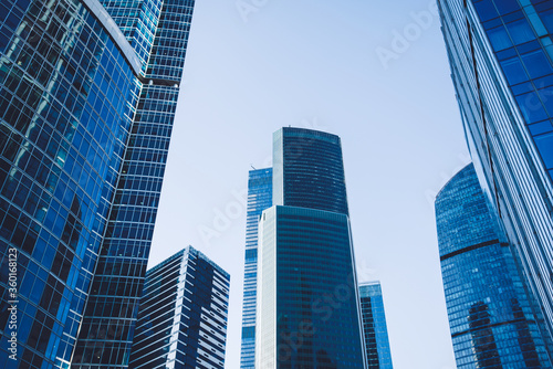 Moscow city with modern business skyscrapers, high-rise contemporary office buildings, architecture raising to the sky, exterior view of big company against blue sky background
