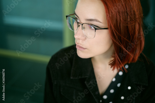 Portrait of beautiful redhead woman wearing glasses.