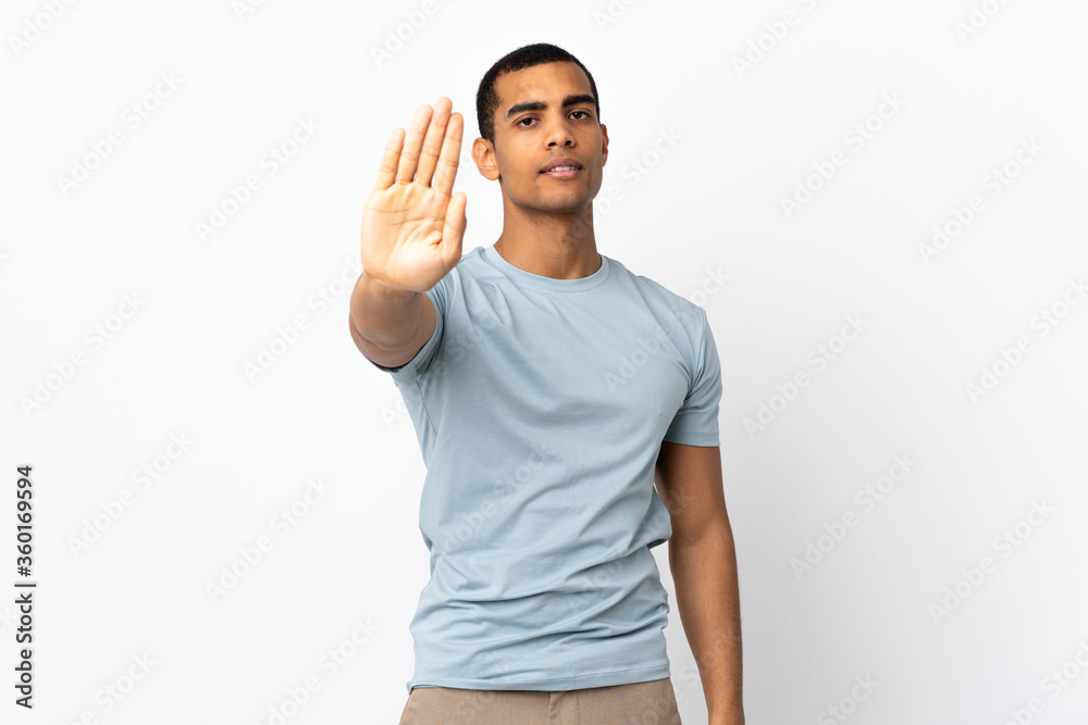 African American man over isolated white background making stop gesture African American man over isolated white background making stop gesture