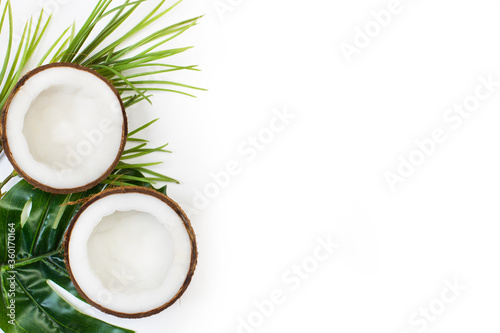 Cocos sobre fondo blanco liso y aislado con hojas. Vista superior. Copy space