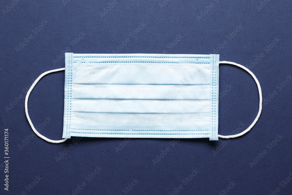 Surgical mask with rubber ear straps. Typical 3-ply surgical mask to cover the mouth and nose. Procedure mask from bacteria. Protection concept. Surgical mask with rubber ear straps. Typical 3-ply surgical mask to cover the mouth and nose. Procedure mask from bacteria. Protection concept.