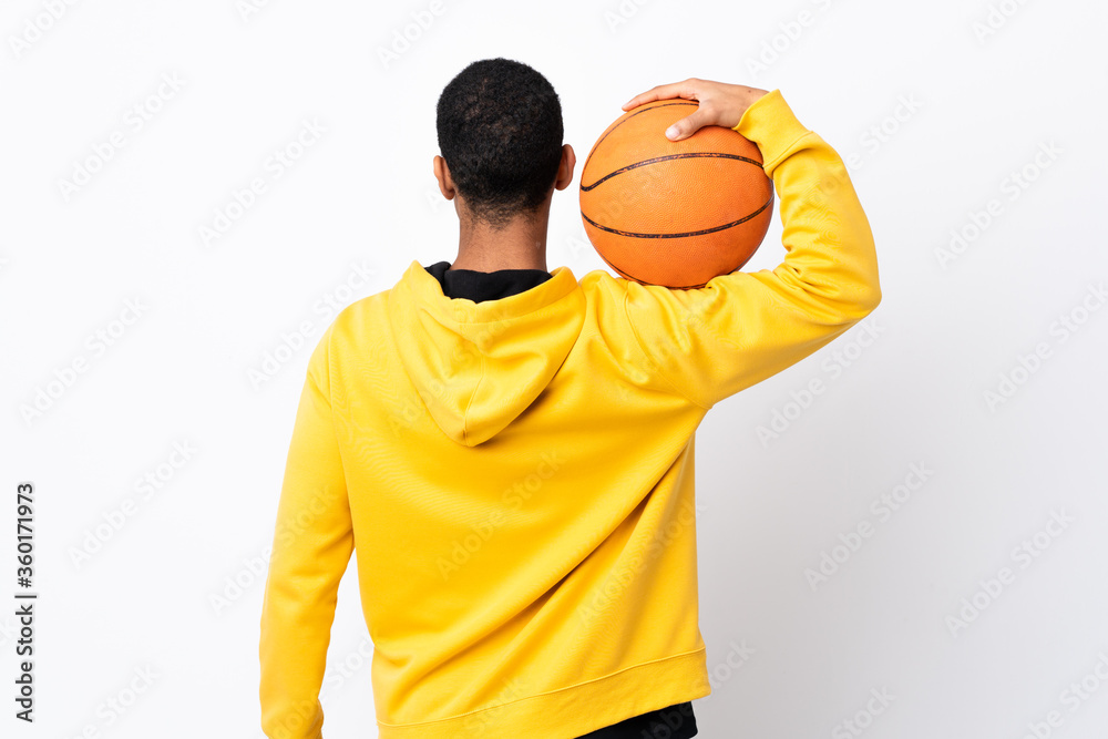 African American man over isolated white background playing basketball in back position African American man over isolated white background playing basketball in back position