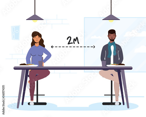 interracial couple dinning in restaurant practicing social distancing ,covid19 prevention method