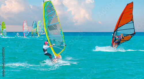 Beautiful cloudy sky with Windsurfer Surfing The Wind On Waves In Alacati - Cesme, Turkey  © muratart