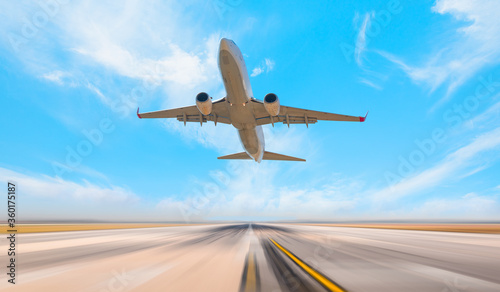 White Passenger plane fly up over take-off runway from airport 