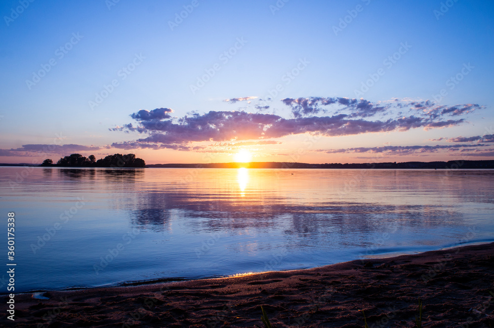 Naklejka premium Magical fairytale sunset in the evening on the lake