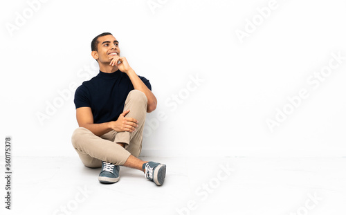 African American man sitting on the floor looking to the side