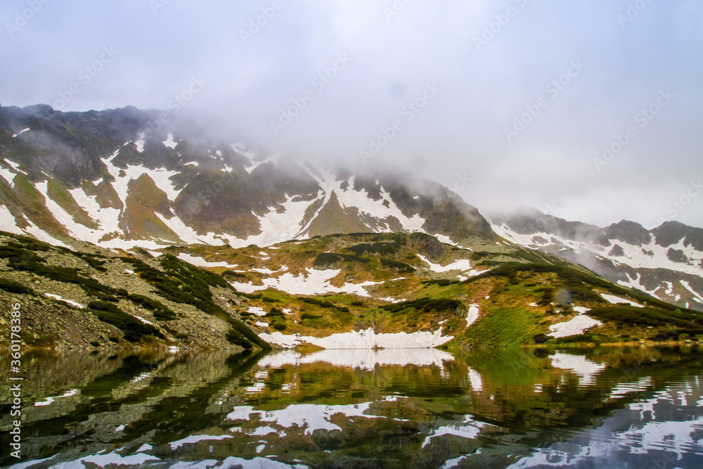 Mountains lakes. Valley of the five ponds in the Tatras. Rainy day. Shooting with raindrops.