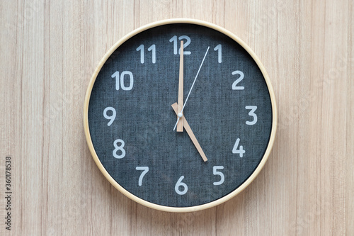 modern clock on wooden wall.