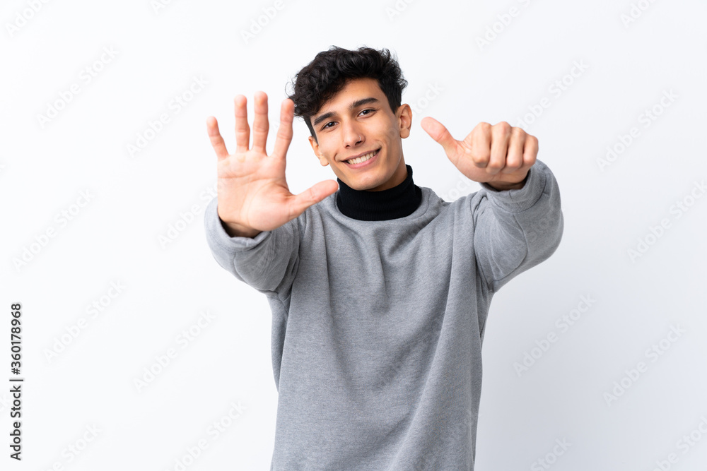 Young Argentinian man over isolated white background counting six with fingers Young Argentinian man over isolated white background counting six with fingers
