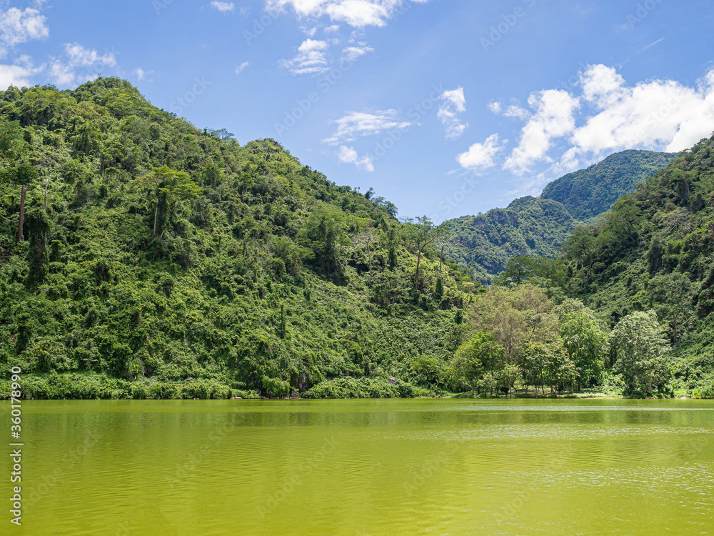 Scenic view of pond and mountains against sky