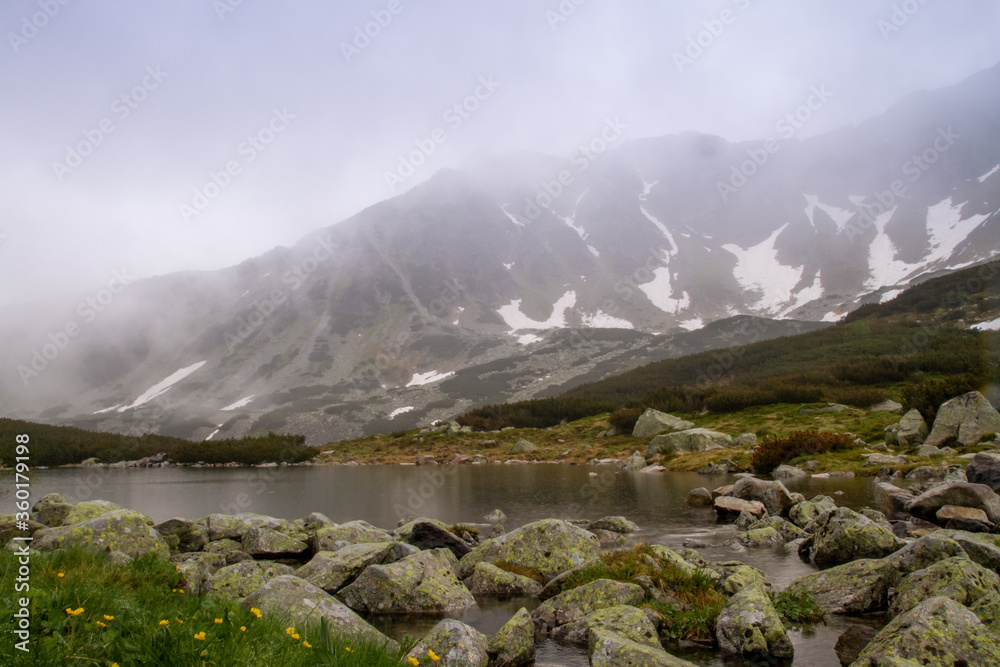 Mountains lakes. Valley of the five ponds in the Tatras. Rainy day. Shooting with raindrops. Mountains lakes. Valley of the five ponds in the Tatras. Rainy day. Shooting with raindrops.