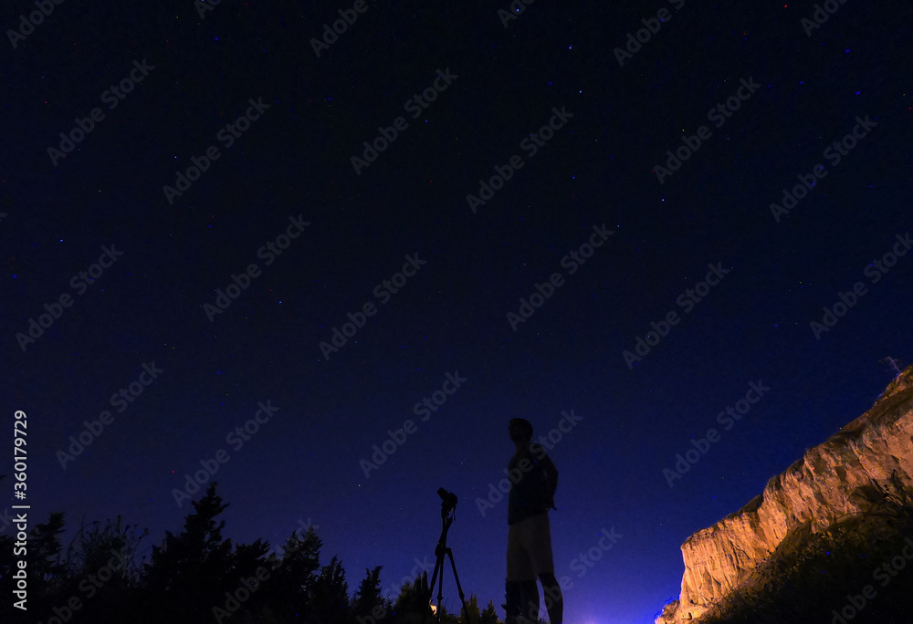 silhouette of a photographer with stars