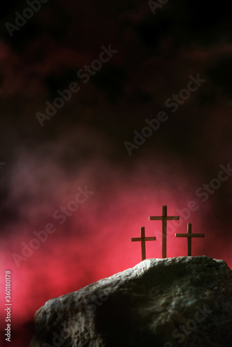 Vászonkép Three crosses against red sky on Calvary hill background