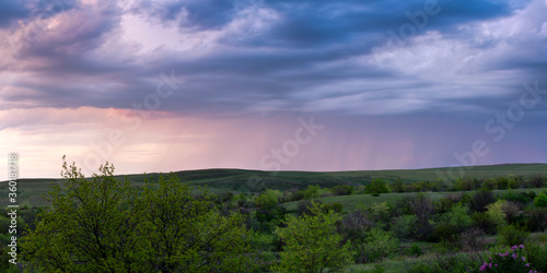 Panorama of the Don steppes in spring  in the distance it is raining  beautiful sunset sky