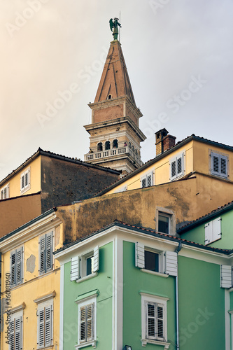 The colourful houses in Piran backdropped by a bell tower.