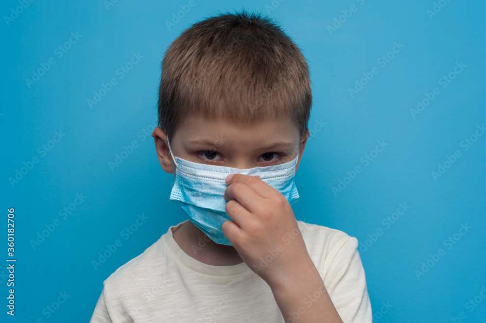 Portrait of child wearing an anti virus protection mask to prevent corona virus.