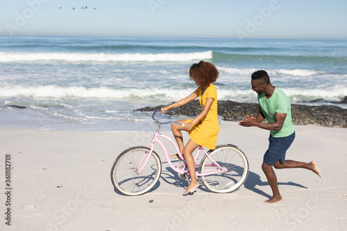 Mixed race couple having fun on the beach