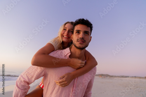 Caucasian couple enjoying time at the beach during the sunset