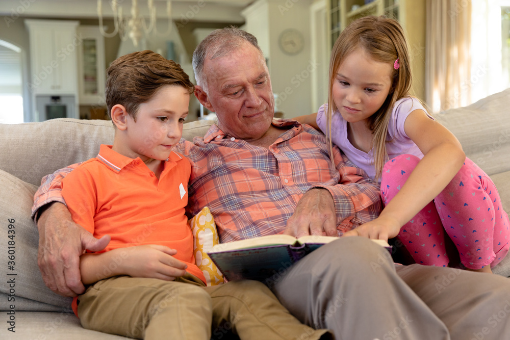 Grandfather and grandchildren at home in the living room Grandfather and grandchildren at home in the living room