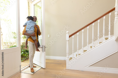 African American man arriving home with his young son