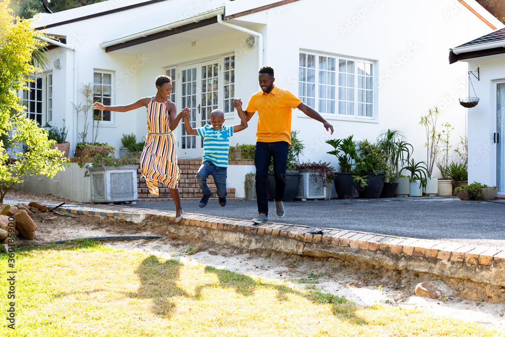 African American family spending time together in their garden. African American family spending time together in their garden.