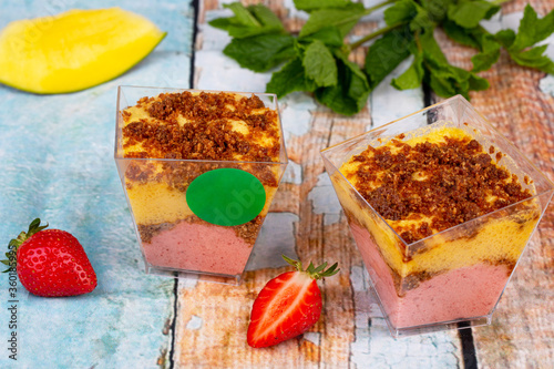 Fruit mousse with the addition of strawberries and mangoes, layered with cramble of rice and almond flour, coconut sugar and coconut oil photo