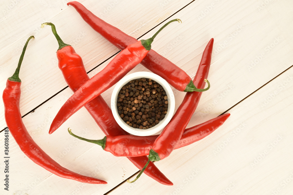 Red chili peppers, close-up, on a white wooden table. Red chili peppers, close-up, on a white wooden table.