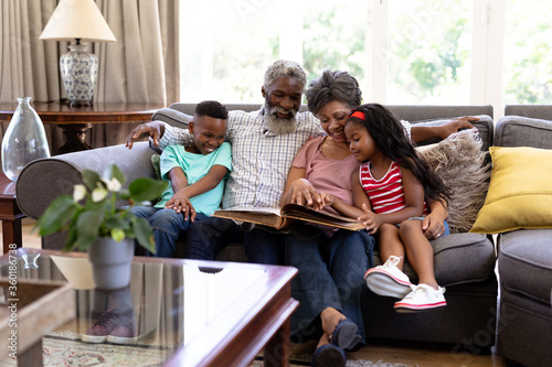 Senior mixed race couple with their grandchildren at home