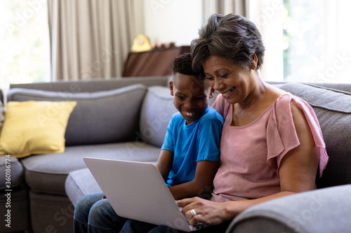 Senior mixed race woman wiith her grandson Using a laptop