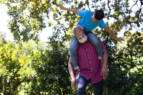 Senior mixed race man and his grandson enjoying his time at a garden