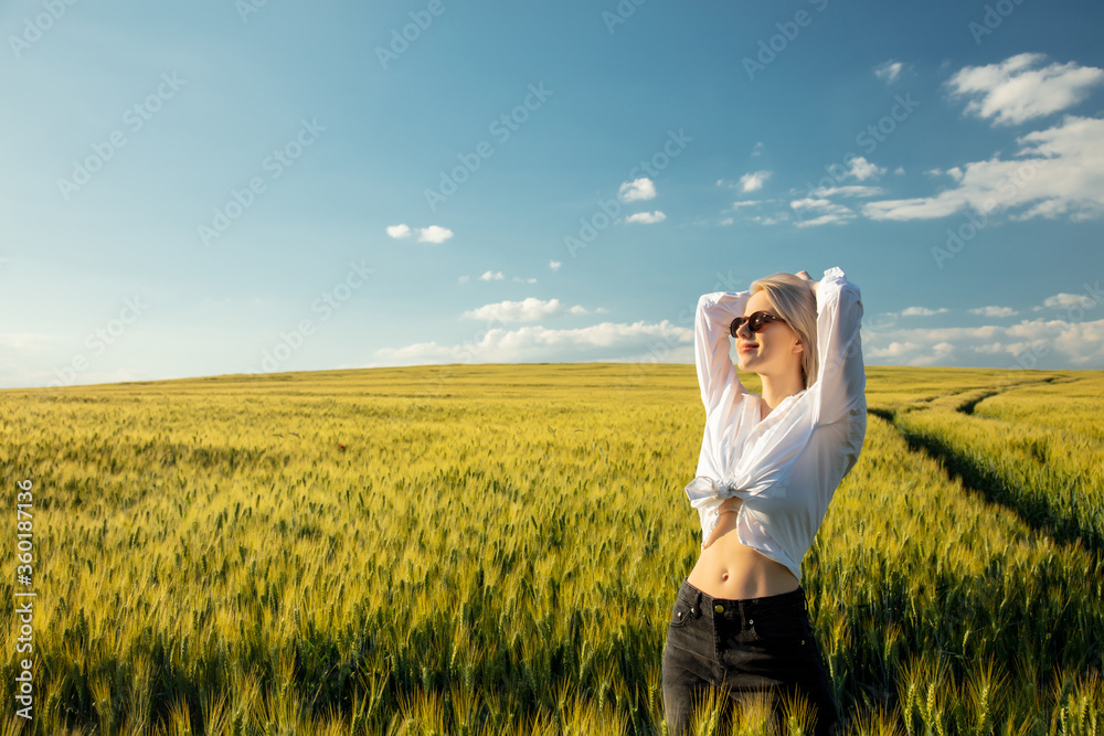 Beautiful blonde woman in wheat field in sunset time Beautiful blonde woman in wheat field in sunset time