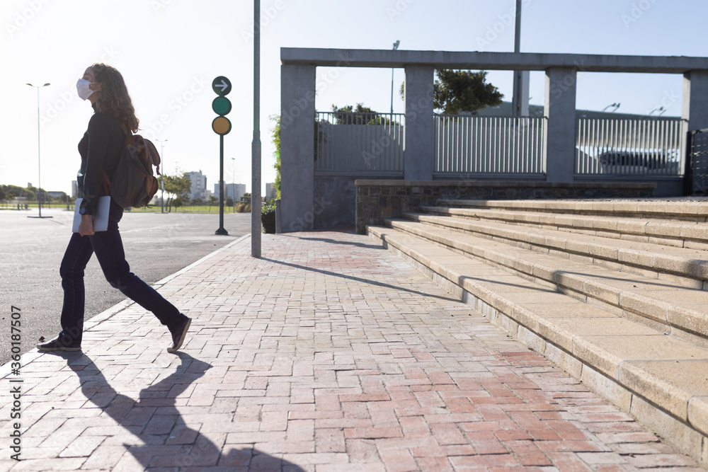 Caucasian woman wearing a protective mask and walking in the streets Caucasian woman wearing a protective mask and walking in the streets