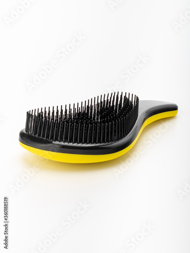 yellow and black hair massage brush