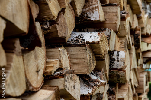 folded woodpile firewood outdoors in a village on a bright summer day