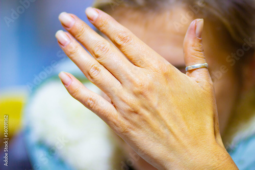 A silver ring on a young woman's hand
