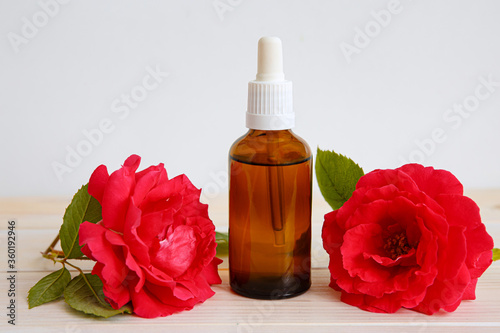 Rose and bottle with aromatic oil or medicine.