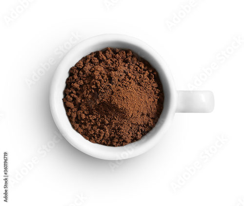 Cup of ground coffee isolated on white background