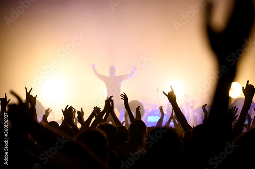 silhouette of a musician on stage and crowd in the hall at a music festival. concert poster. blurred concert atmospheric photo