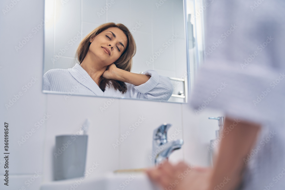 Attractive lady spending time in bathroom in the morning Attractive lady spending time in bathroom in the morning