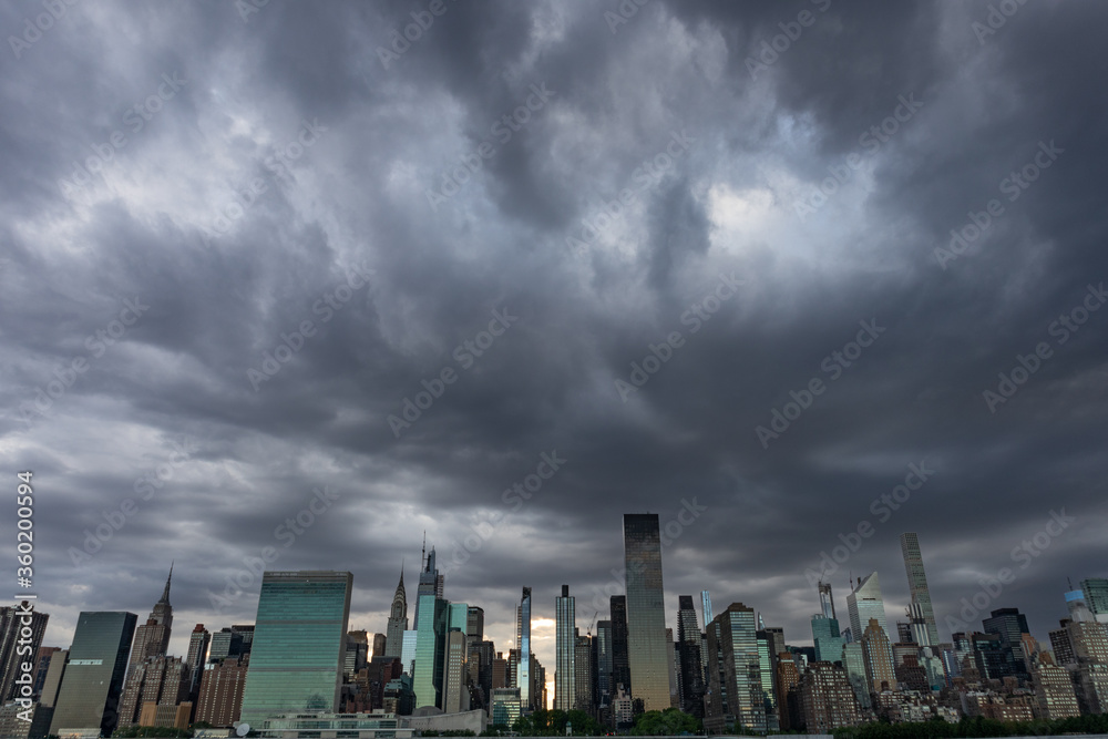 Dark and Creepy Midtown Manhattan Skyline during a Sunset with Large Ominous Clouds in New York City